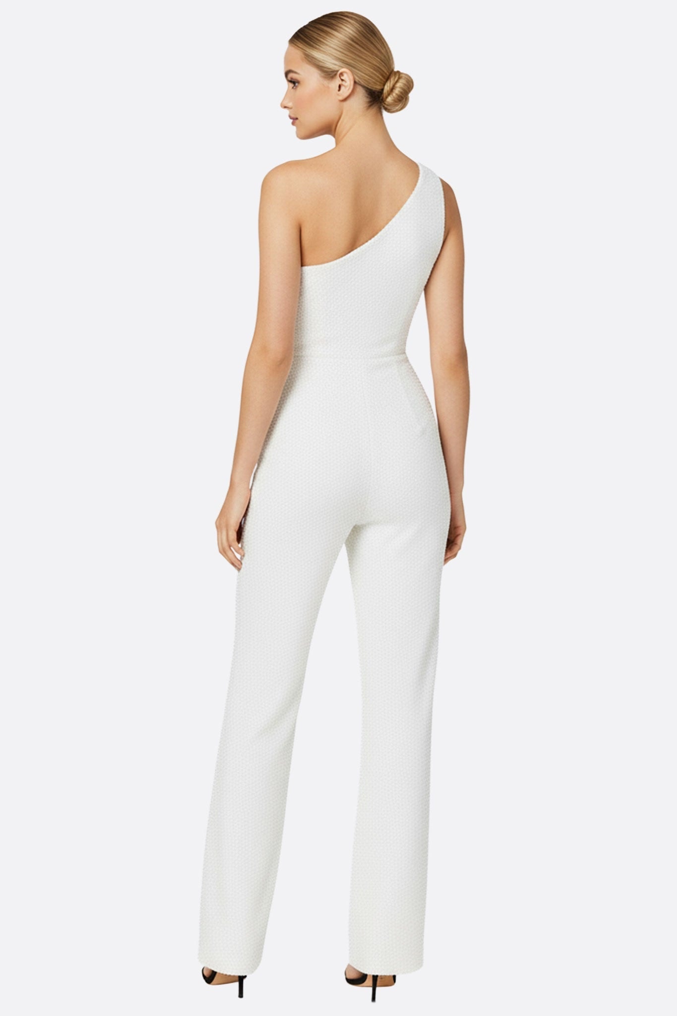 Close-up of the white jumpsuit with tonal sequins, a bold choice for a refined evening look