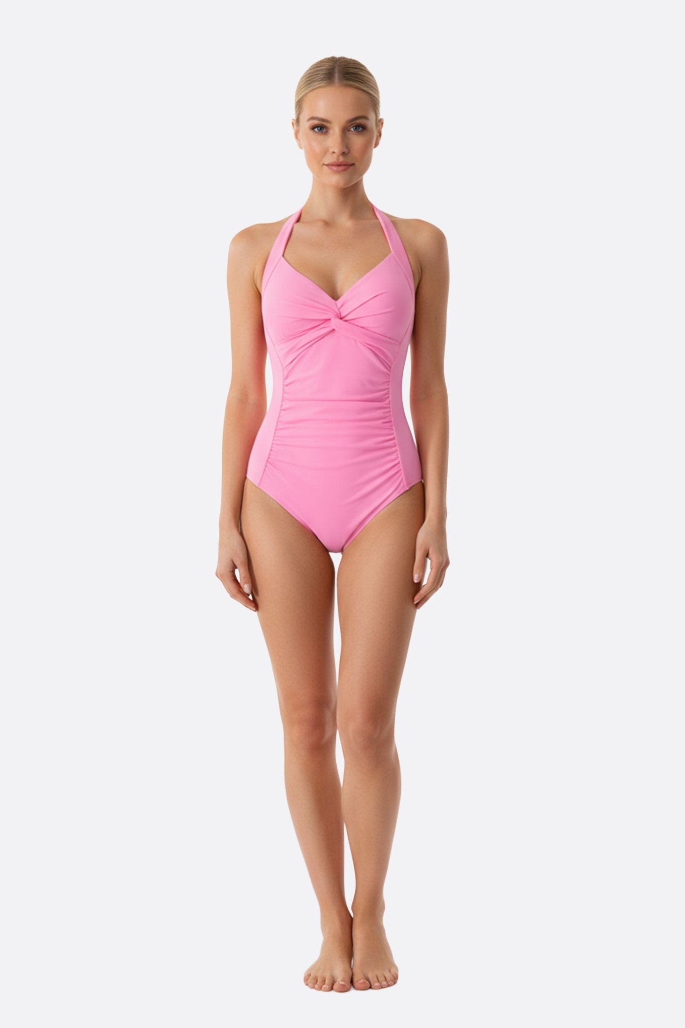 Maillot de bain une pièce délicat en rose pâle, noué à l'avant, parfait pour une journée à la plage élégante.