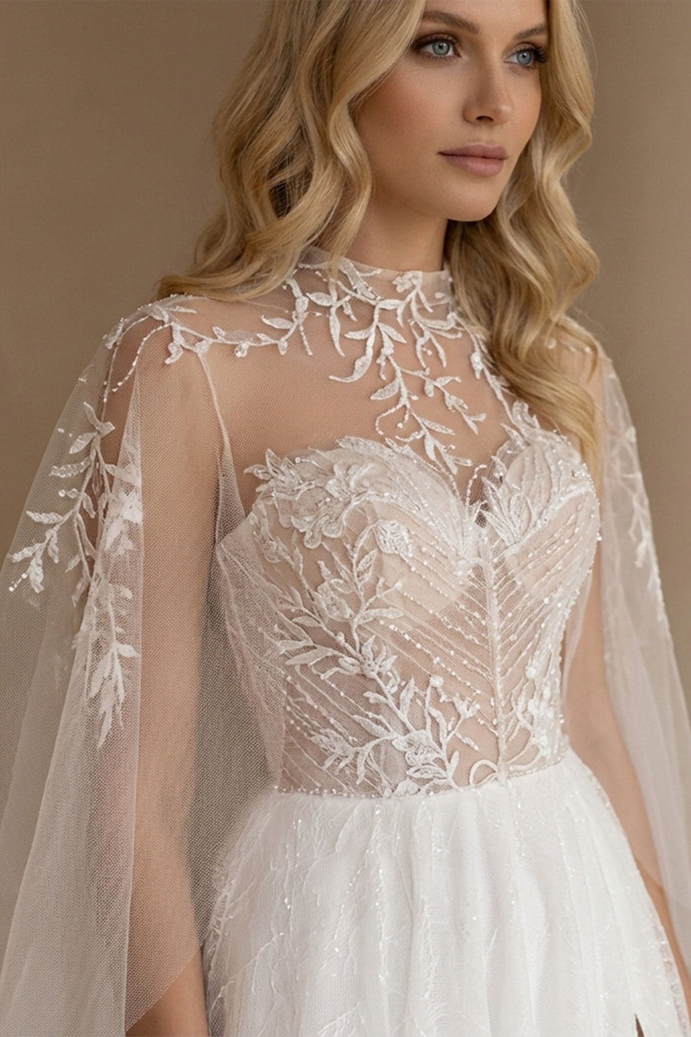 Captivating detail of the Alena wedding dress, white tulle bustier and delicate overcoat, perfect for a celebration...